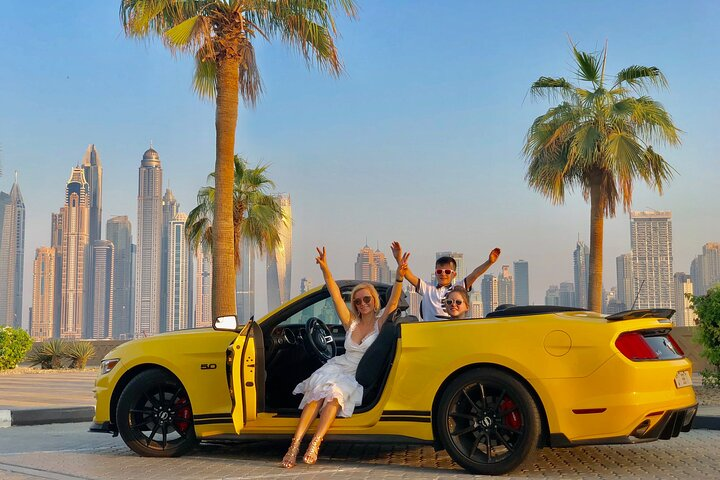 Feel the wind as you cruise through Dubai's skyline in a sleek convertible. Experience iconic landmarks like Burj Khalifa and luxury hotels while capturing unforgettable moments.